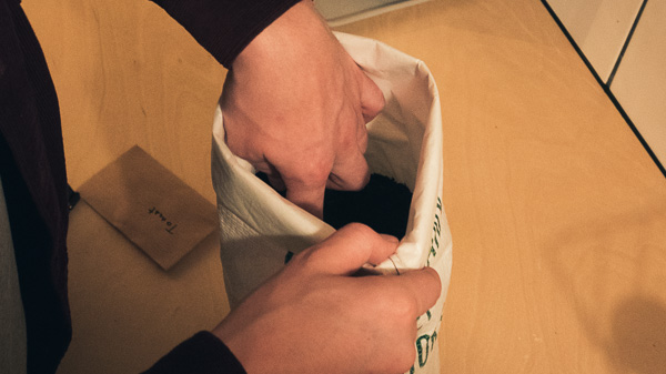 Customer sowing the seeds in the compost in the bag