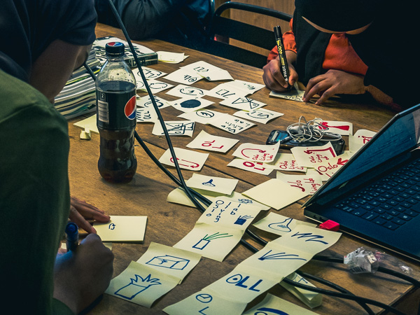 Youth employees sketching 20 logo ideas each in 20 minutes