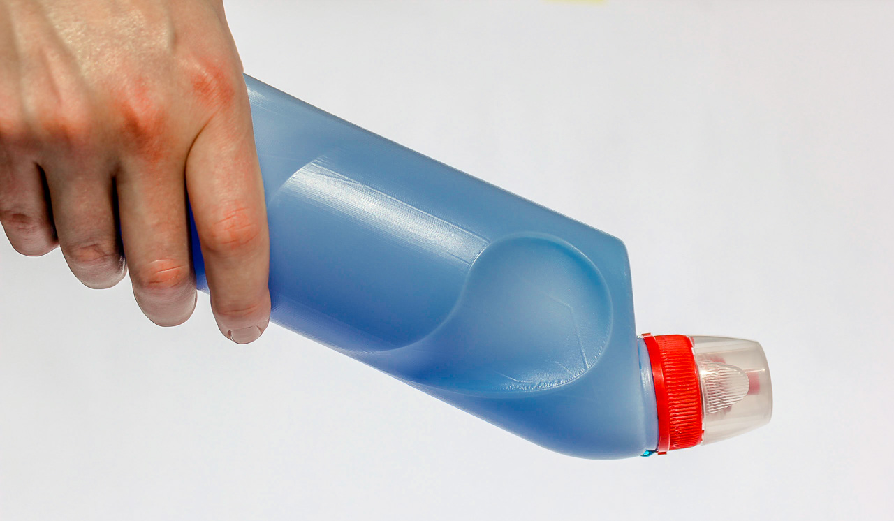Hand holding blow molded bottle